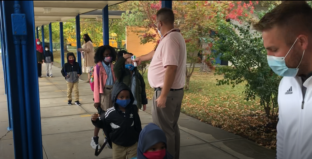 Utica Academy of Science elementary school students are getting their temperatures screened with masks prior to entering the building.