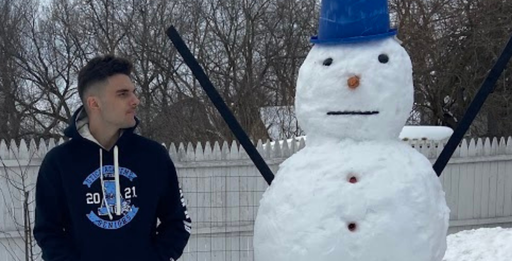 Amar Halimanovic, 1st place winner, poses next to his snowman he built for the Utica Academy of Science National Honors Society’s first-ever Snowman Building Contest.