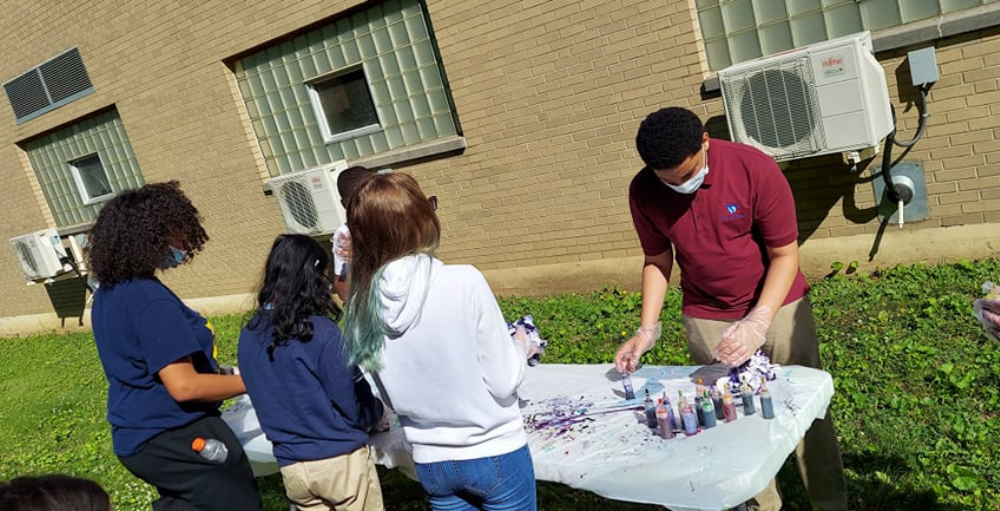 Utica Academy of Science middle school students create their own commemorative tie-dye t-shirt during their Field Days event.
