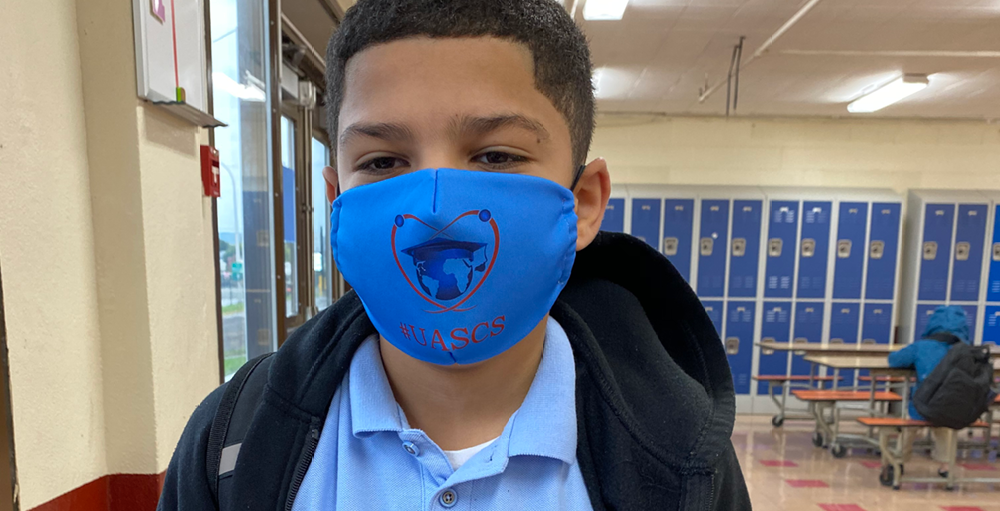 A custom face mask with the school logo for the 2020 - 2021 school year